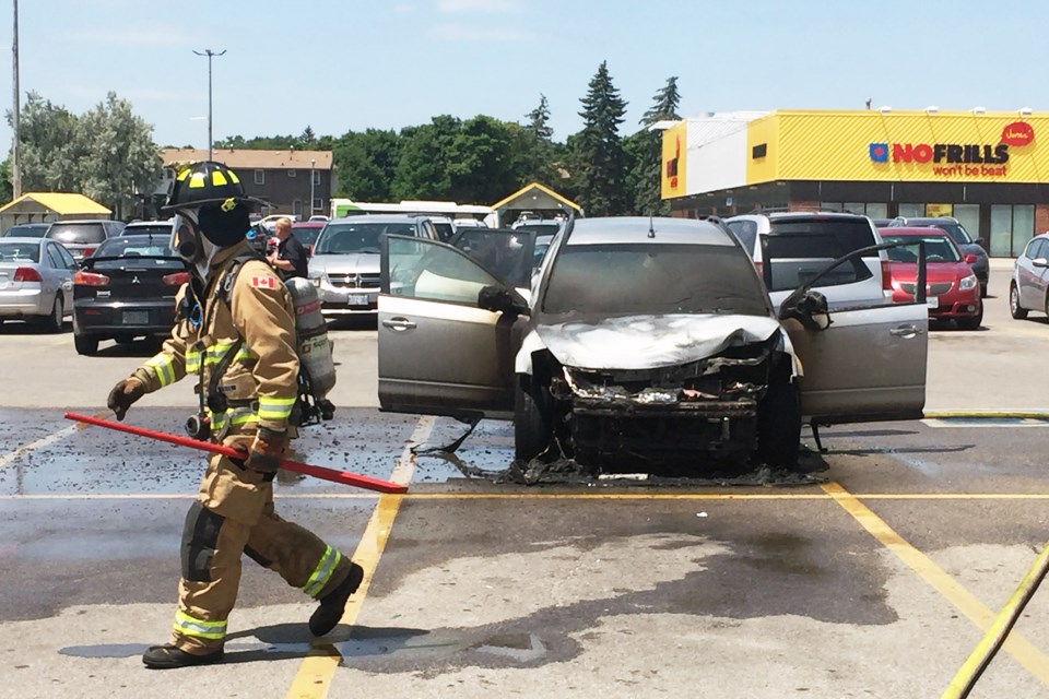 Firefighters with the Guelph Fire Department on the scene of a car fire July 4, 2018 on Silvercreek Parkway at Willow Road. 