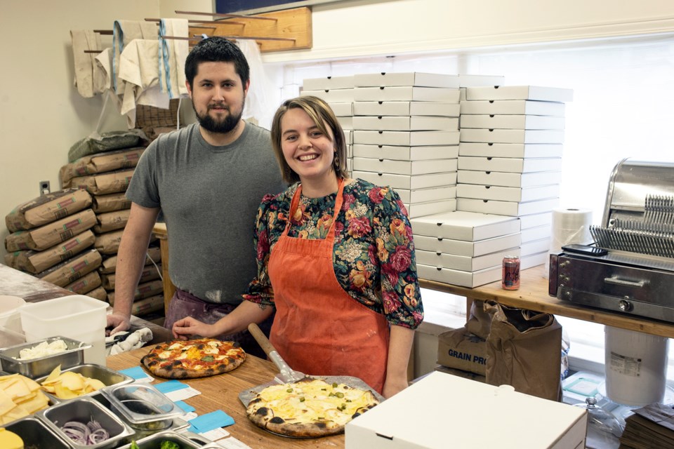 Jesse Wallace and Abby Richter are two of four people operating the pop-up Pie by Night pizza shop on Sundays at Polestar Hearth bakery. Kenneth Armstrong/GuelphToday