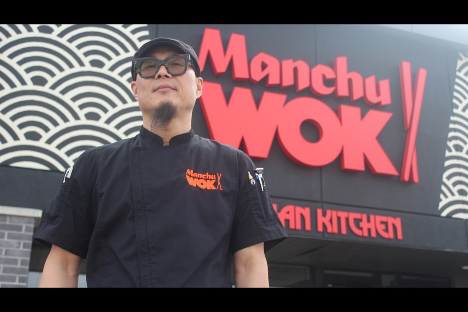 John Lee, the culinary innovations and corporate chef for ManchuWOK, stands outside the franchise's first non-mall location in Guelph.