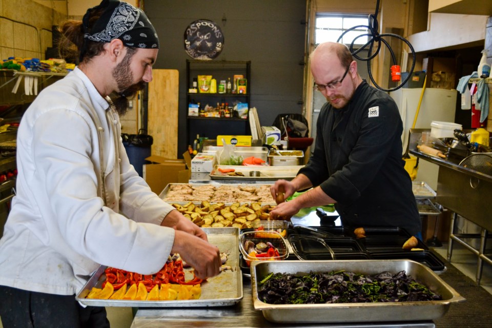 Chefs Andrezej Rutkowski and Will Phillips prepare meals to be delivered to clients. Briana Bell for GuelphToday