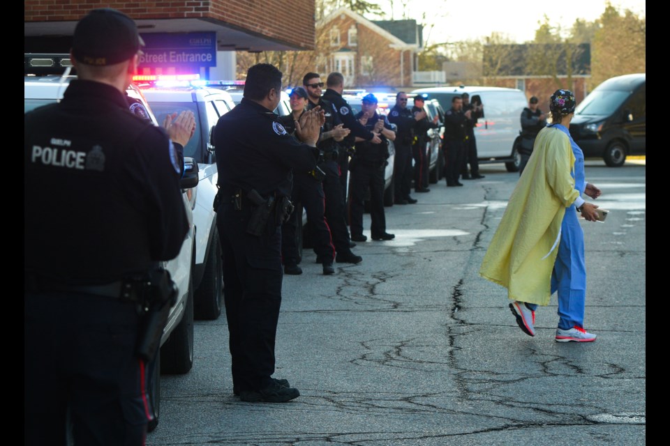 A Guelph General Hospital staff member gets a round of applause from Guelph Police during a show of support outside the hospital on Wednesday. Tony Saxon/GuelphToday