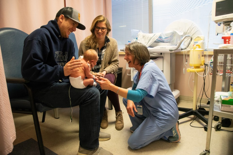 One-week-old Abbott Wideman holds on to the finger of nurse Jackie Sanvido while parents Ben Wideman and Rebecca Barrett-Wideman look on. Plans for a proposed renovation of the Special Care Nursery will include rooms with beds for the parents to stay with their baby. Kenneth Armstrong/GuelphToday
