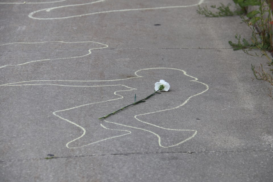 White roses were left on top of the outlines in memory of those who have died from drug poisonings. Next year, they would like attendees to bring pictures of those they wish to remember.