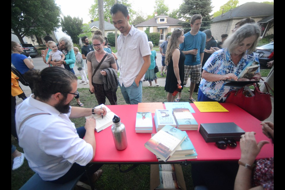 Jared Brock signs copies of his book outside Heritage Hall Saturday. Tony Saxon/GuelphToday