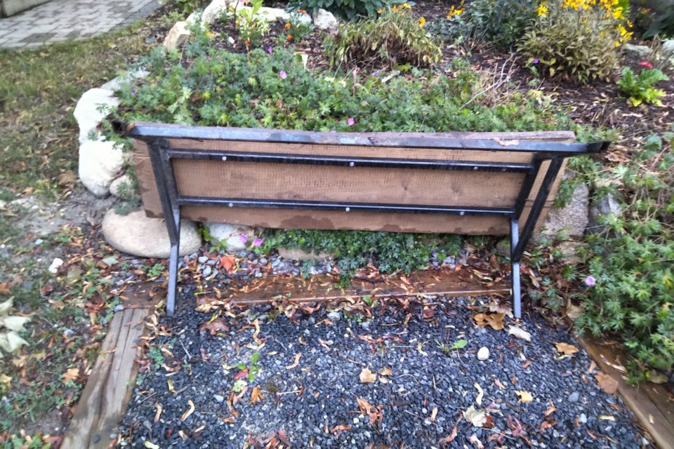 The bench in front of the pollinator garden at Heritage Hall was ripped out of the ground and toppled over this past weekend. The bench was installed in 2020 in memory of Norwood Francis. 