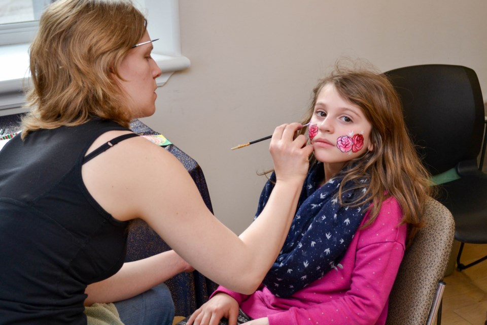 Chloe, 7, getting her face painted by Makin' Faces Face Painting. Photo by Daniel Bell for GuelphToday. 