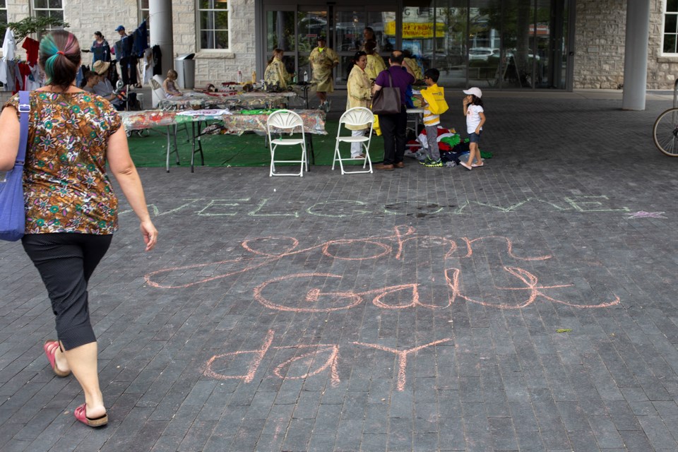A message in chalk welcomes people to The city of Guelph's John Galt Day celebrations, held Saturday, Aug. 4 at City Hall. Kenneth Armstrong/GuelphToday