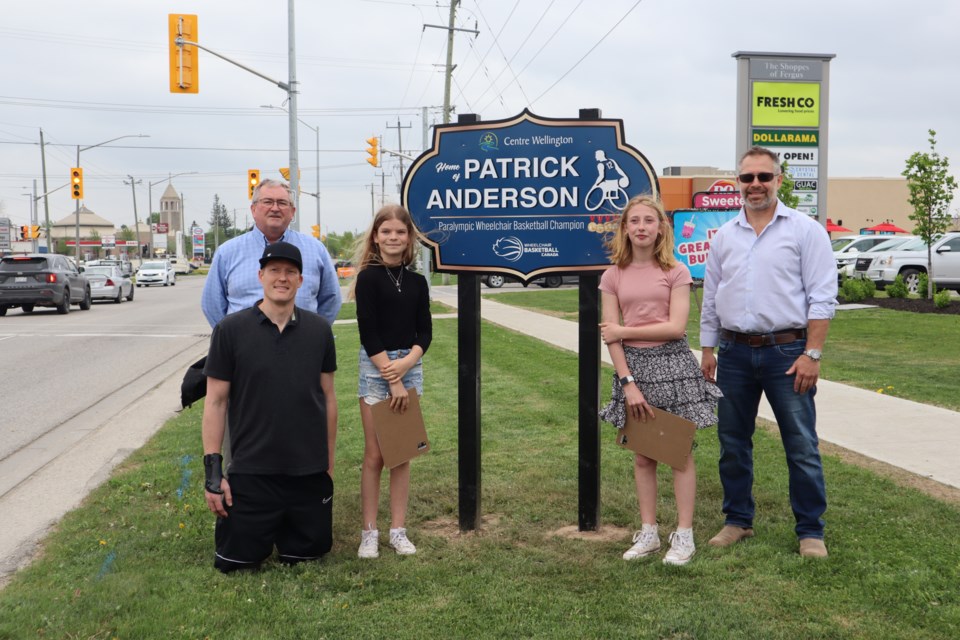 Left to right: Coun. Neil Dunsmore, Patrick Anderson, Mya Hunt, Lily Brown and Mayor Kelly Linton in front of the "Home of" Patrick Anderson sign at 875 St David St North in Fergus.