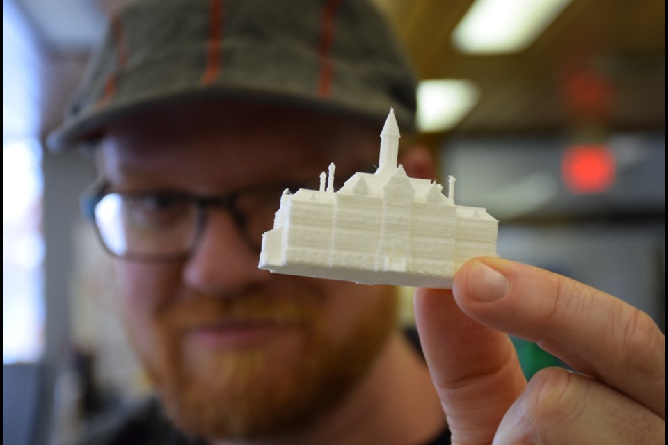 Educational consultant Kyle Mackie with a tiny 3D printed model of Central Public School as it once was. Rob O'Flanagan/GuelphToday