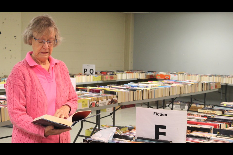 Brenda Walton, a member of the Friends of the Guelph Public Library book sale marketing committee, peruses through one of the many books available at this year's book sale.