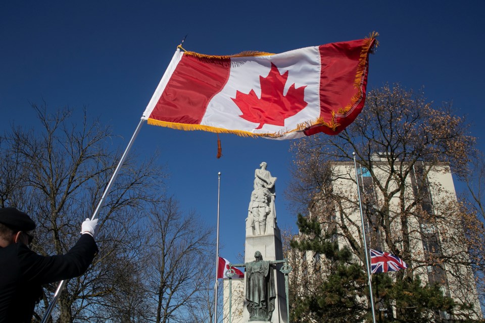 A member of the colour party holds up a flag during the 11 a.m. Remembrance Day service in Guelph. Kenneth Armstrong/GuelphToday