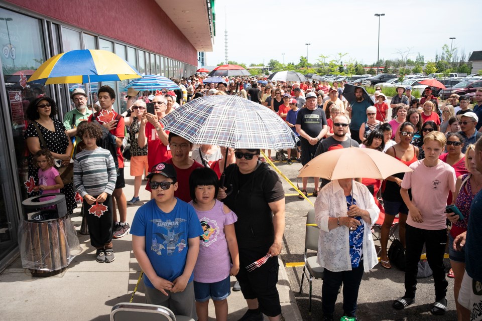 Hundreds in line for a free Canada Day meal at the Mandarin restaurant in Guelph on Monday. Kenneth Armstrong/GuelphToday