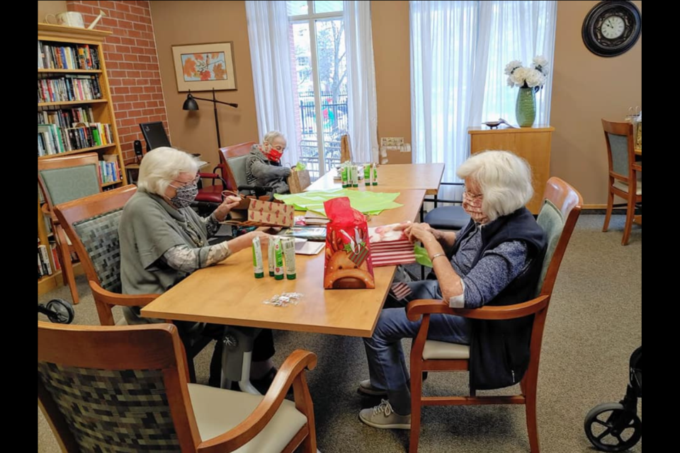 Residents at The Elliot Community enjoying some items in a care package from Students Supporting Seniors in December 2020.