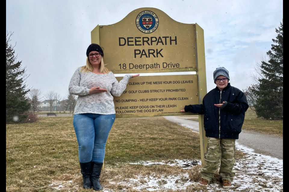 Lindsey Oman, left, posing with the sign for Deerpath Park.