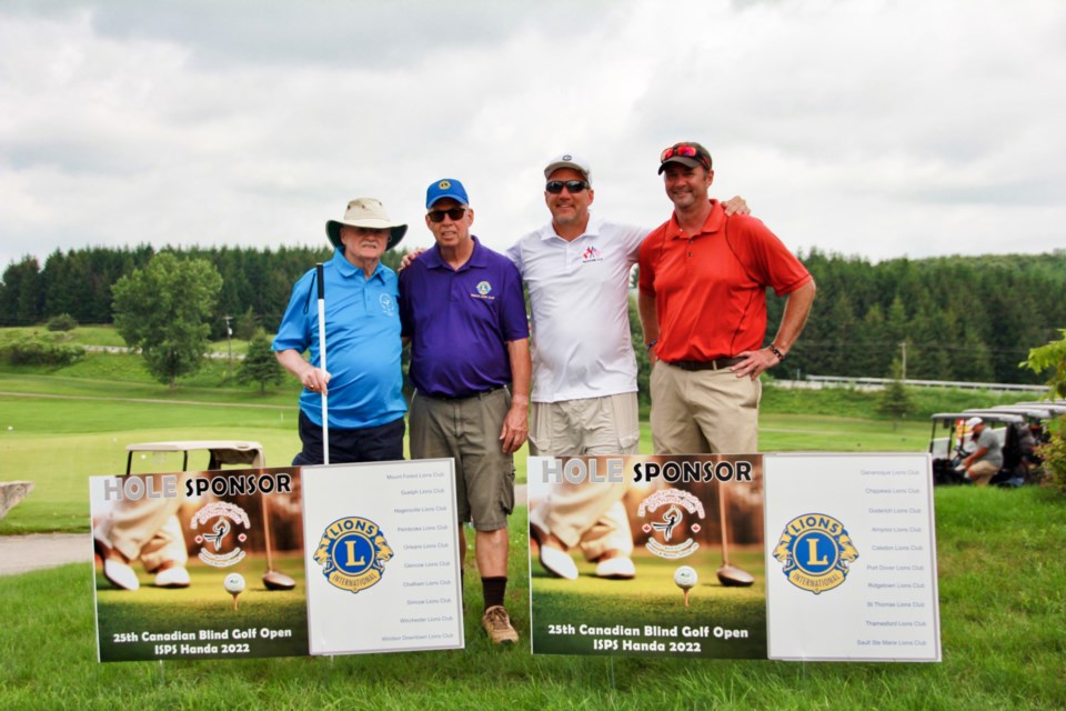 Jim Saunders, far left, and Rick Kush, centre right, in a group photo.