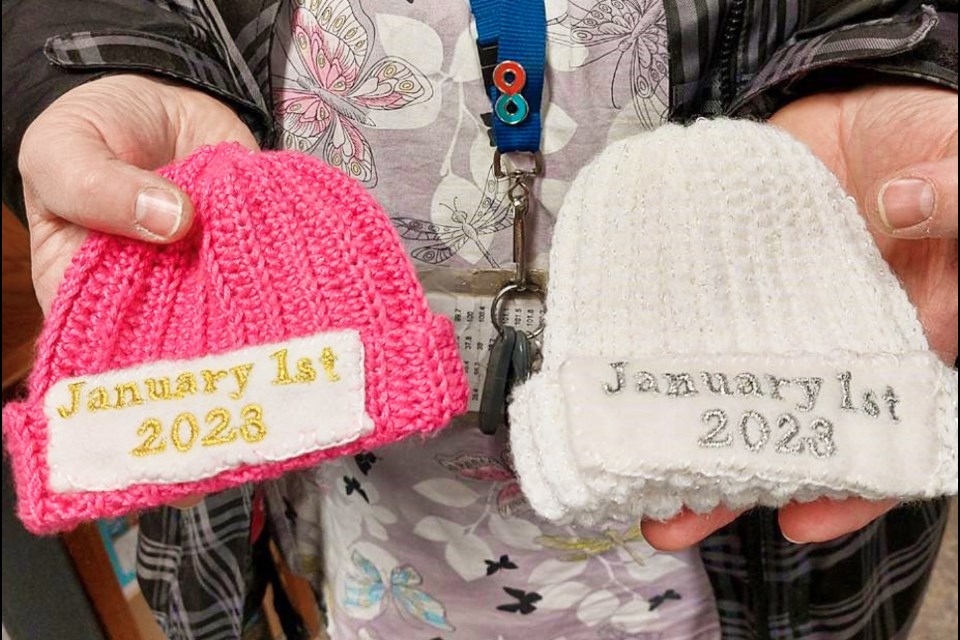 Alison and Janet Dunkley made the white and pink baby hats and did the embroidery reading 'January 2023' at the makers space in the Guelph Public Library Westminster branch.