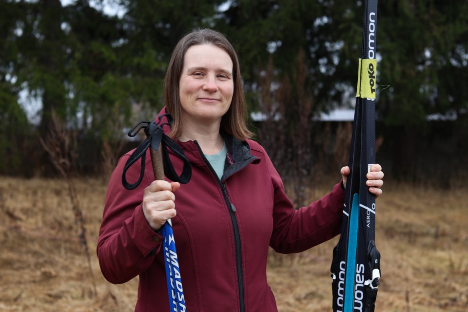 Caroline Prochazka stands with her skis on the snowless Guelph Nordic Ski Club trails, located on the grounds of the Ignatius Jesuit Centre.