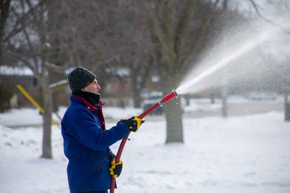 Mike Darmon sprays a layer of water on the community outdoor ice rink in Riverside Park. He is one of a number of volunteers across the city who keep the community rinks maintained. Kenneth Armstrong/GuelphToday