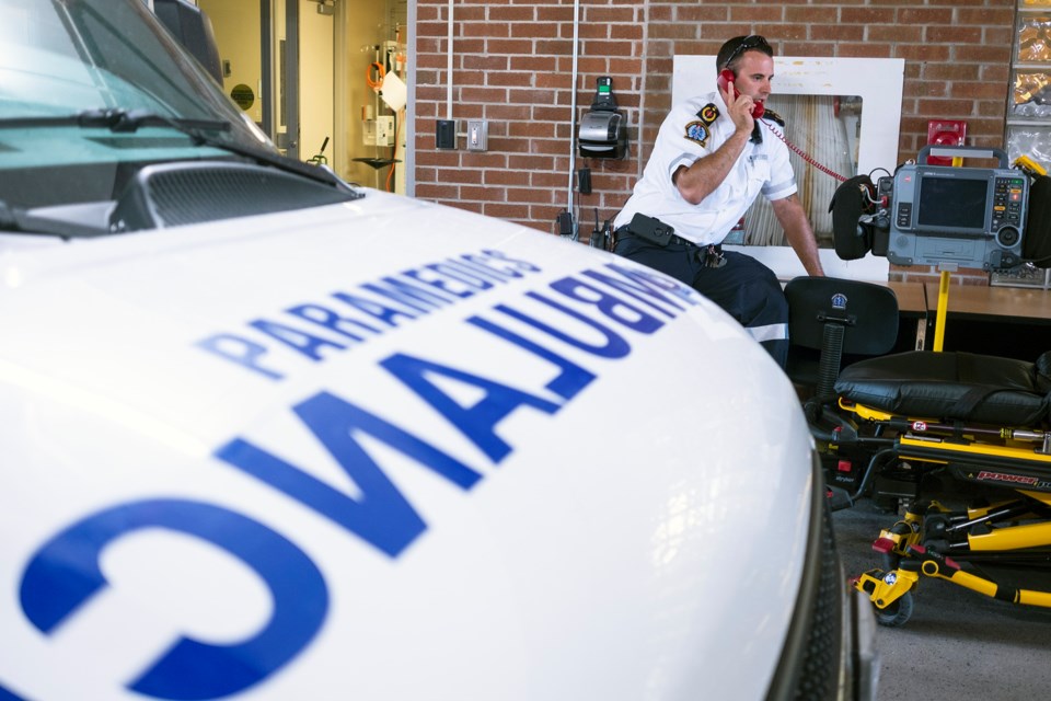 Paramedic supervisor Joe Draper calls dispatch on a direct line from the ambulance bay of Guelph General Hospital. Each stations and post in the Guelph-Wellington Paramedic Service has a similar red 'bat phone' to contact dispatch directly. Kenneth Armstrong/GuelphToday