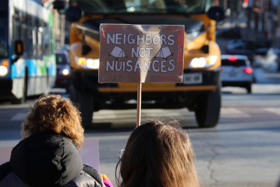 More than 30 people gathered Wednesday morning to protest the proposed public space use bylaw, starting on the steps of the Basilica and marching into city hall. 