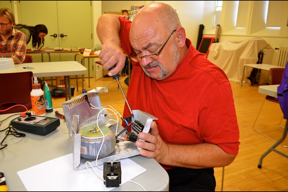 Volunteer fixer Tony Boog repairing an isolation transformer. (Troy Bridgeman for GuelphToday)
 
