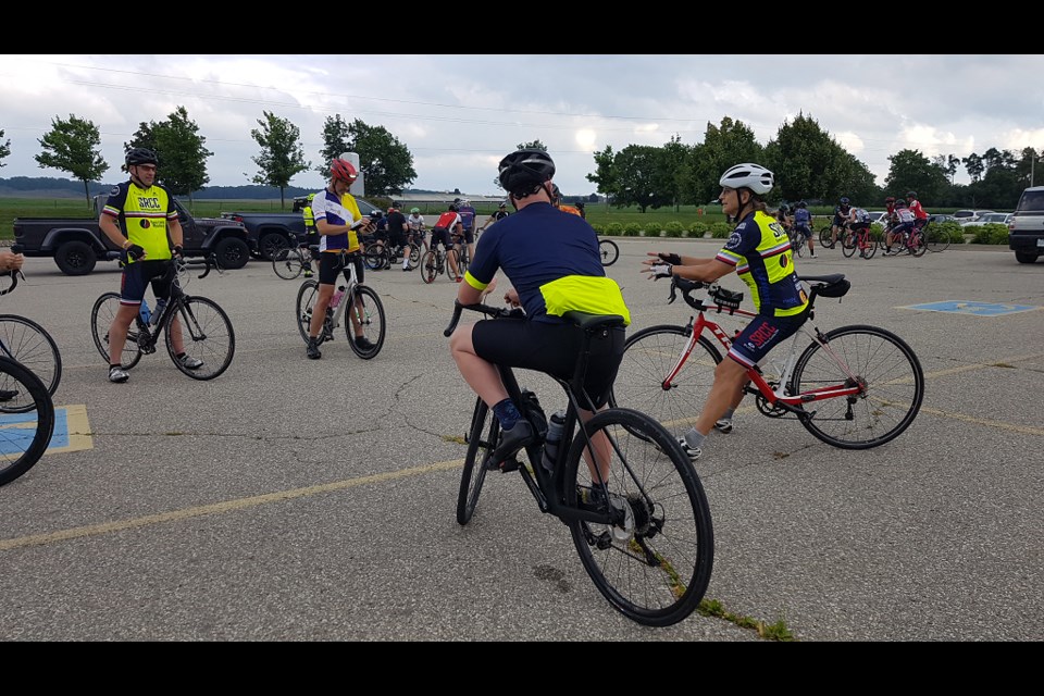 The Guelph Cycling Club member experience director Meg Thorburn (white helmet on right) provides some instructions to riders.