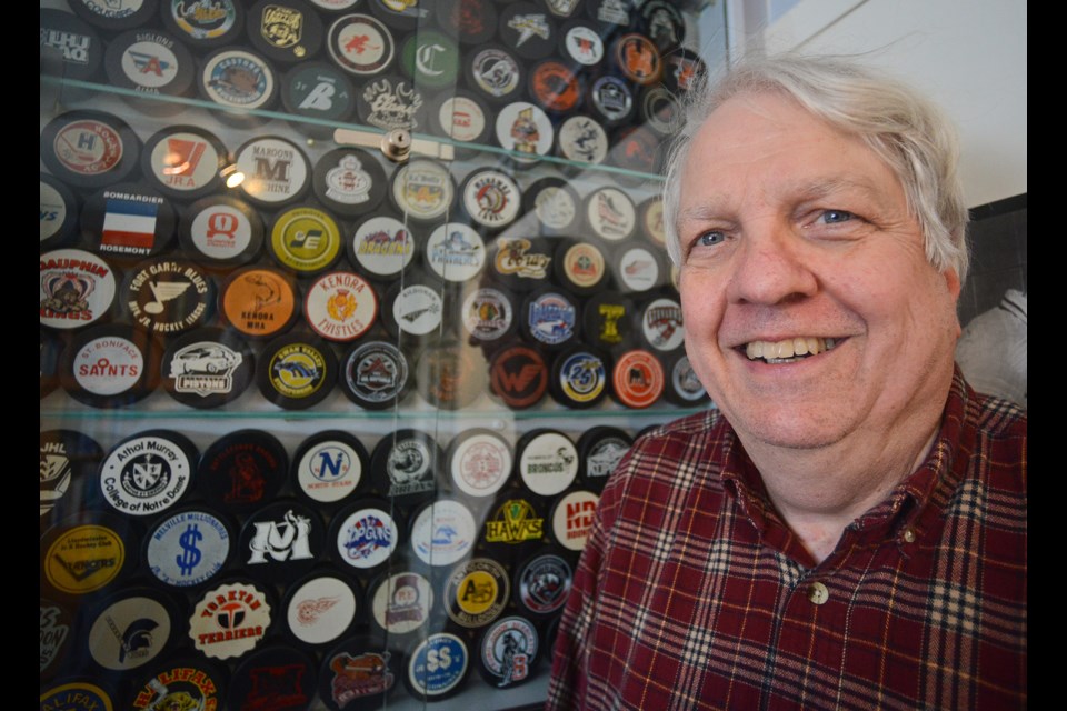 David Kendrick stands beside just a portion of his almost 2,700 hockey puck collection. Tony Saxon/GuelphToday