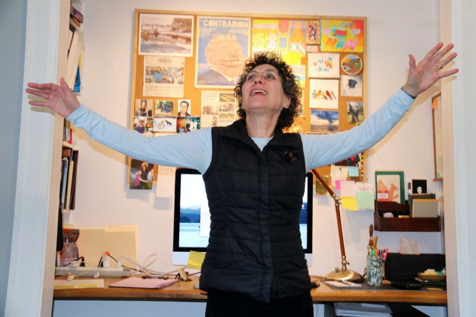 Barbara Salsberg Mathews dancing in her office. 