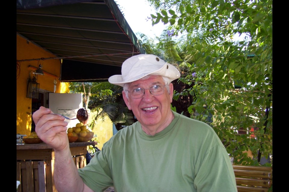 Lloyd Hetherington sitting outside in a white hat.