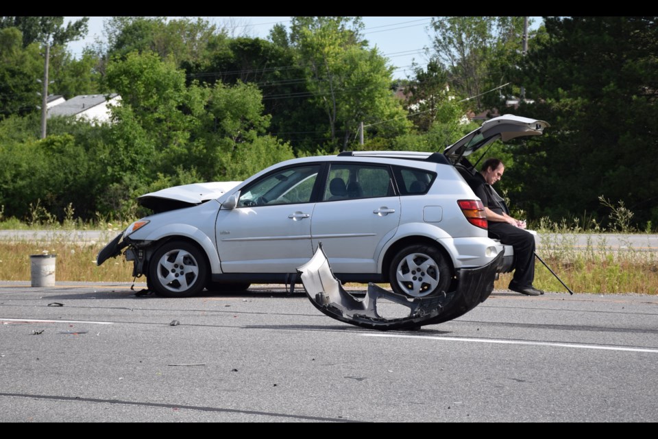 The driver of a Pontiac Vibe fills out the paperwork after a Wednesday morning collision on the Hanlon Expressway.  (Rob O'Flanagan/GuelphToday)
