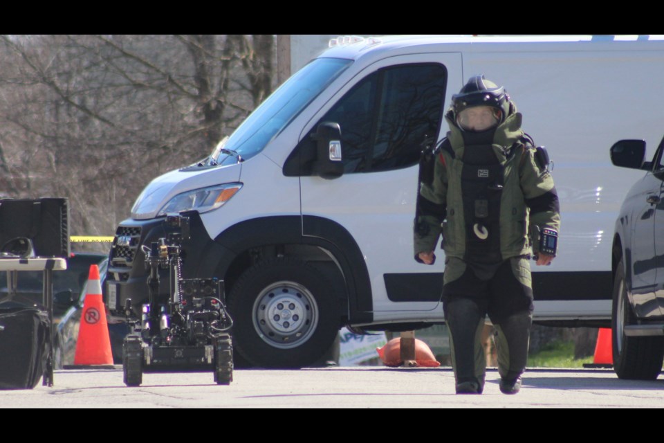 Waterloo's bomb squad robot was called in to check out a unit at 70 Ontario St. after a man was injured and later arrested for possessing an explosive device.