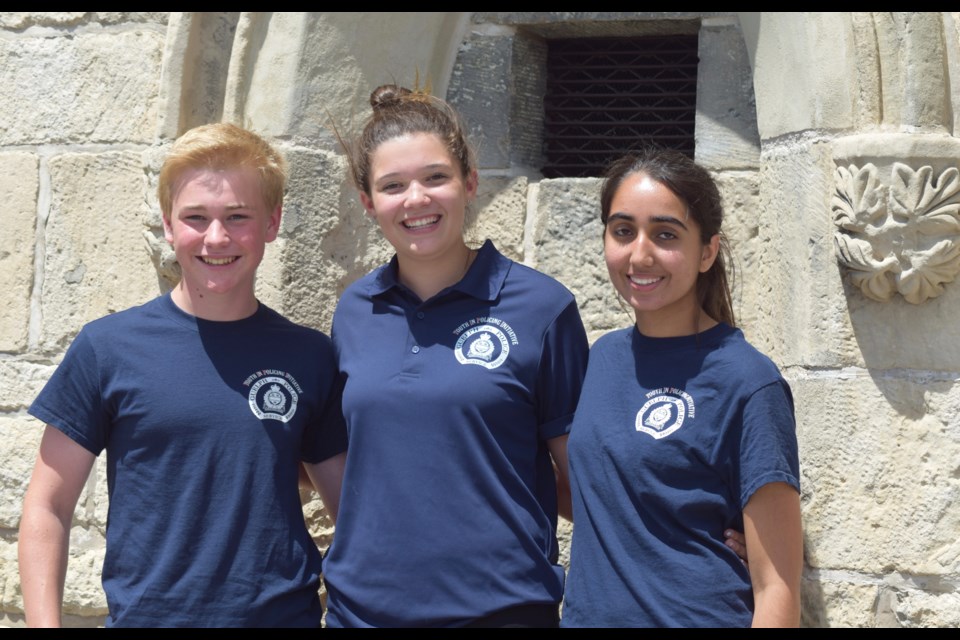 Three aspiring police officers are part of the Guelph Police Youth in Policing Initiative this summer. From left, Alex Tout, Adrianna Vanos, and Iman Aziz were hired from 50 applicants. (Rob O'Flanagan/GuelphToday) 