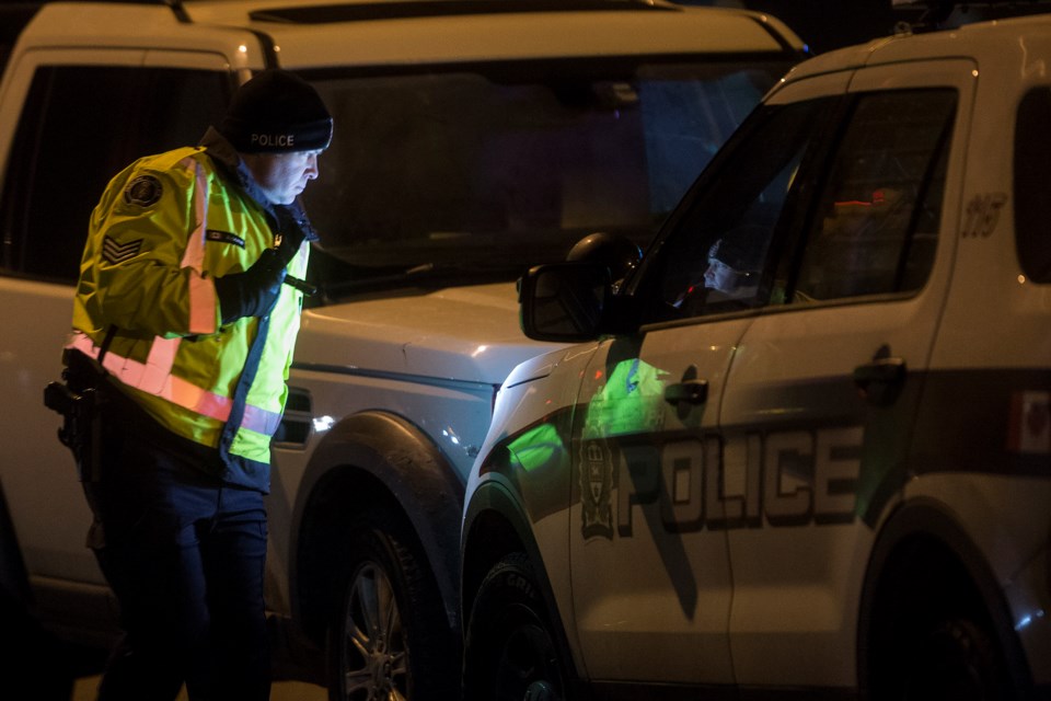 An officer with the Guelph Police Service looks at a police cruiser that collided with a Land Rover head on late afternoon Sunday on College Street at the Hanlon Expressway. Kenneth Armstrong/GuelphToday