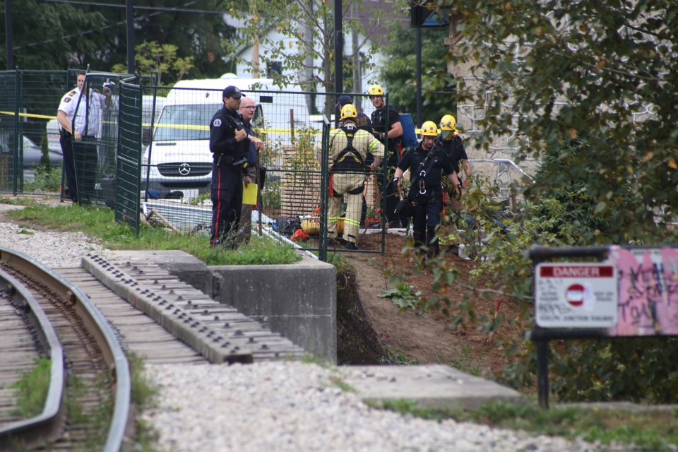 First responders prepare to scale down a steep incline to recover a body found early Thursday morning near the intersection of Wellington and Arthur streets. Kenneth Armstrong/GuelphToday