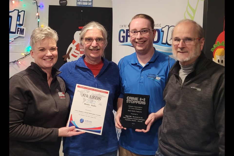 Sarah Bowers-Peter, program coordinator for Crime Stoppers Guelph Wellington, presents the CSI Award for Best Radio to The Grand at 101's McKim Ecclestone, while Austin Cardinell holds the OACS award for Best Radio, along with Rob Dutton during episode of Swap Talk.