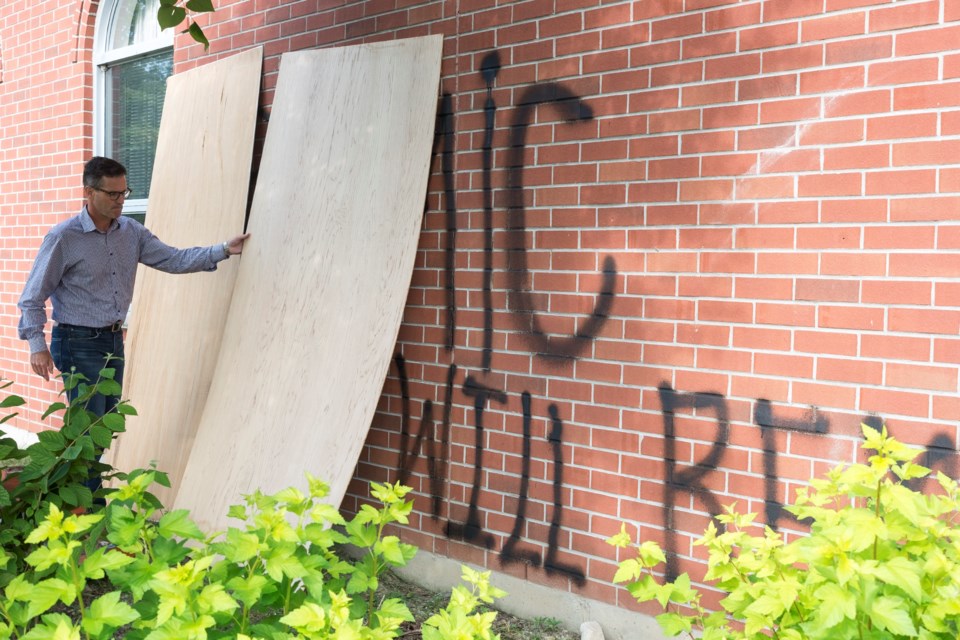 Jeff Groenwald, interim senior leader of Lakeside Church, seen Tuesday uncovering Islamic State messaging that was spray-painted on the front facade of the building Sunday evening or very early Monday morning. Kenneth Armstorng/GuelphToday