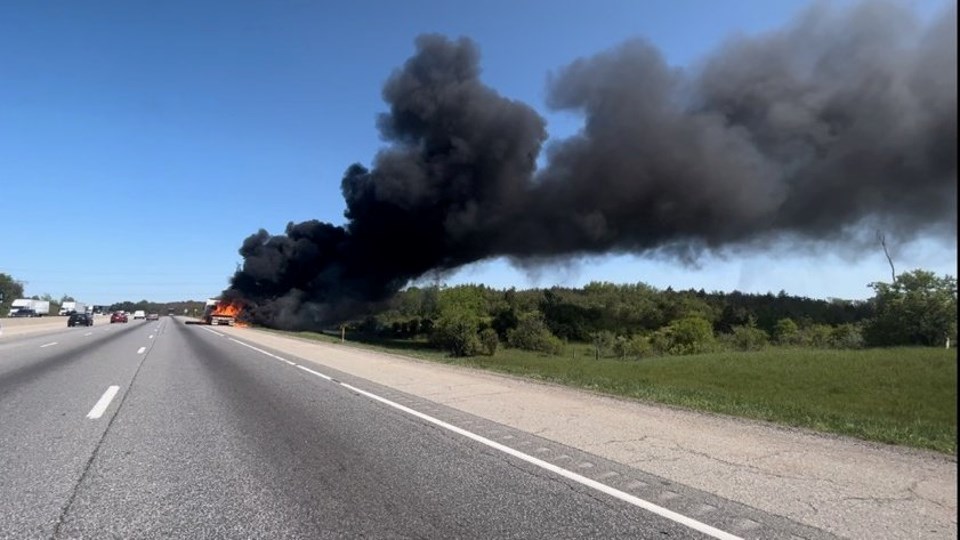 Firefighters douse a tractor trailer fire on the side of Highway 401 between Highway 6 north and Highway 6 south.