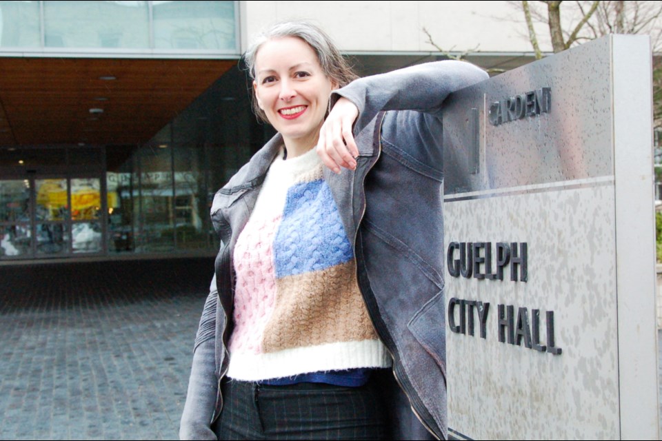 Erin Caton, the first known city councillor who identifies as non-cisgendered, stands in front of city hall.