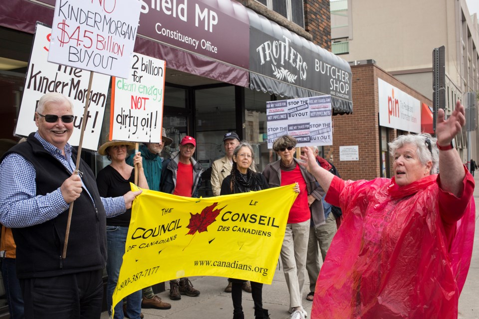 People in protest of the Kinder Morgan Pipeline seen Monday outside the office of Guelph MP Lloyd Longfield. Kenneth Armstrong/GuelphToday