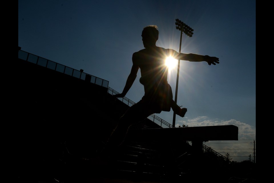 Steeplechaser Chris Winter clears a hurdle at Alumni Stadium during practice for Canada's Olympic distance team. Tony Saxon/GuelphToday