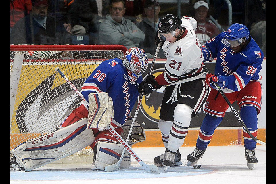 James McEwan of the Guelph Storm goes to the net looking for the puck as Kitchener Rangers goalie Dawson Carty and defenceman Elijah Roberts try to stop him Sunday, Oct. 16, 2016. Tony Saxon/GuelphToday