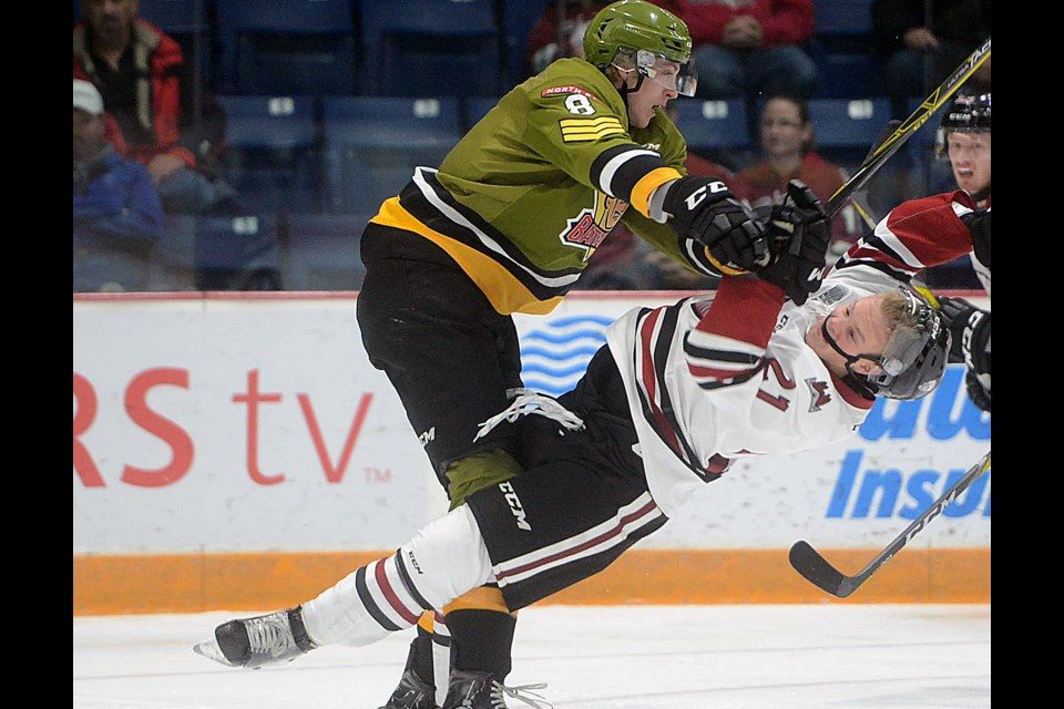 North Bay Battalion defenceman Riley Bruce levels Guelph Storm forward James McEwan with a check Friday, Oct. 21, 2016, at the Sleeman Centre. Tony Saxon/GuelphToday