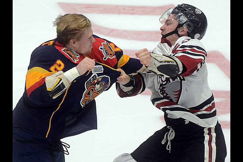 Mitchell Byrne of the Erie Otters, left, fights with the Guelph Storm's Luke Burghardt Friday, Dec. 2, 2016, at the Sleeman Centre. Tony Saxon/GuelphToday