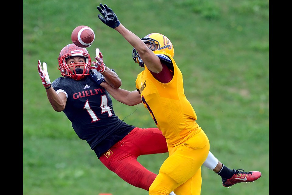 Kian Schaffer-Baker of the Guelph Gryphons keeps his eye on the prize as he attempts to make a catch over a Queen's defender Saturday, Sept. 10, 2016, at Alumni Stadium. Tony Saxon/GuelphToday