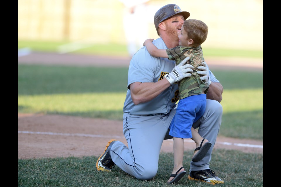 Kitchener Panthers slugger Sean Reilly is greeted by his son Aiden at home plate after tying the Intercounty Baseball League all-time home run record with a first inning bomb against the Guelph Royals Tuesday, June 22, 2016 at Hastings Stadium. Tony Saxon/GuelphMercury