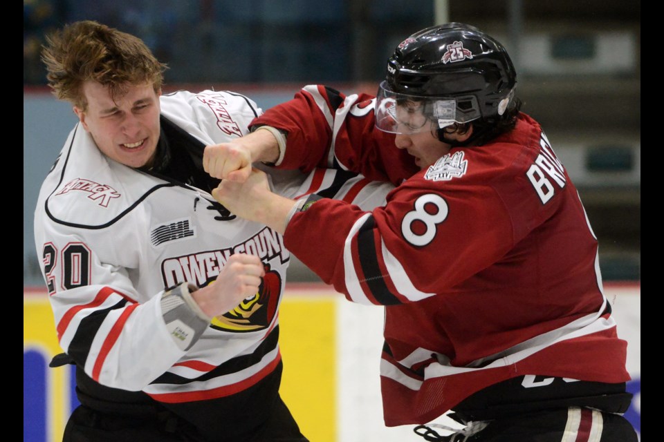 The Guelph Storm's Jake Bricknell, right, dukes it out with the Owen Sound Attack's Tyler MacArthur Friday, March 18, 2016, at the Sleeman Centre. The Storm lost it's last home game of the season 5-2. Tony Saxon/GuelphToday