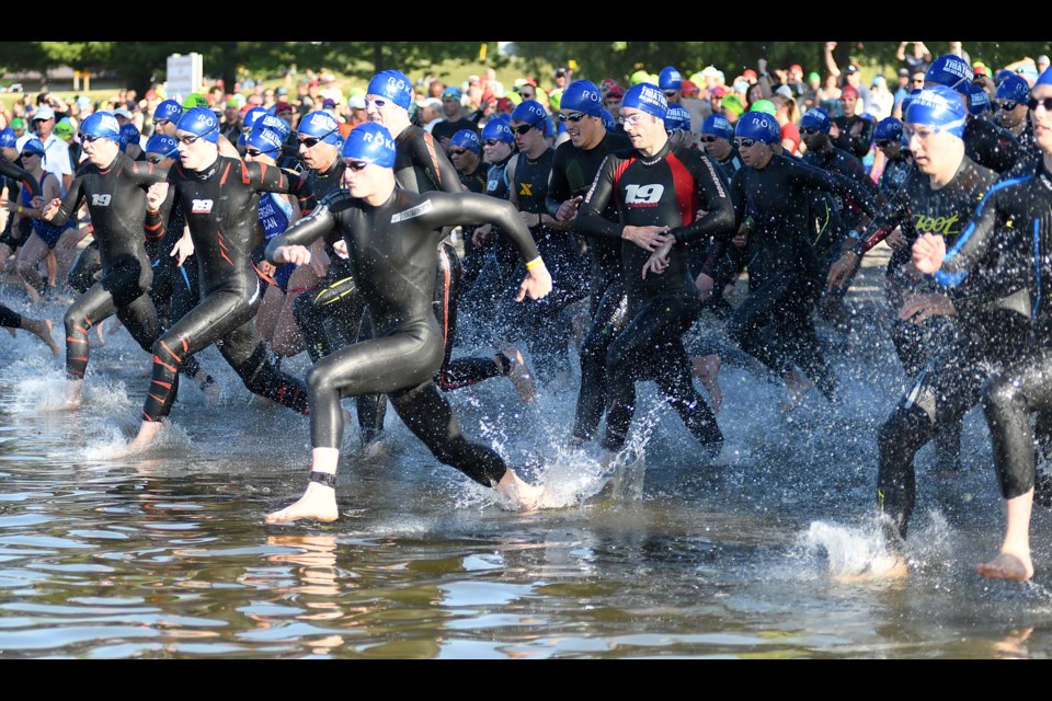 Triathletes dash into the water to start Guelph Lake One's Olympic triathlon Saturday. University of Guelph student and varsity swimmer Myles Zagar won the event. Rob Massey for GuelphToday