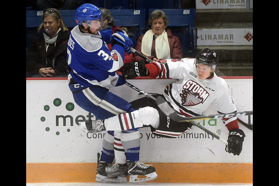 Kyle Rhodes, left, of the Sudbury Wolves knocks down the Guelph Storm's Owen Lalonde Sunday, Nov. 12, 2017, at the Sleeman Centre. Tony Saxon/GuephToday