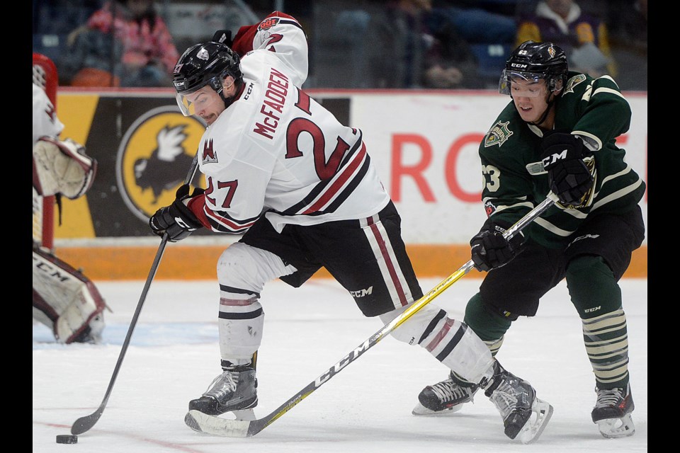 The Guelph Storm's Garrett McFadden is chased by the London Knights' Cluff Pu during action at the Sleeman Centre Sunday, Nov. 26, 2017. Tony Saxon/GuelphToday