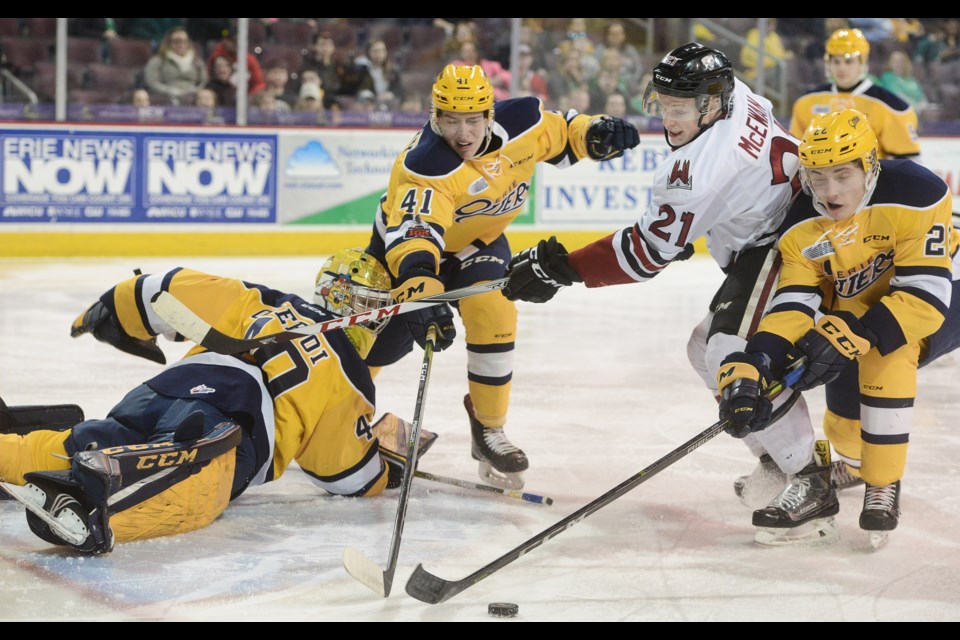 The Guelph Storm's James McEwan is surrounded by Erie Otters Saturday, March 17, 2018, in Erie. Tony Saxon/GuelphToday